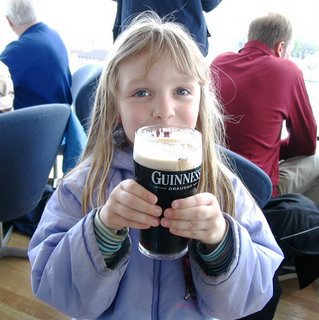 Little girl drinking Guinness